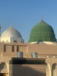Stunning view of the green and white domes of Al-Masjid an-Nabawi in Madinah, Saudi Arabia.