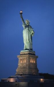 Stunning nighttime view of the Statue of Liberty on Liberty Island, New York City.